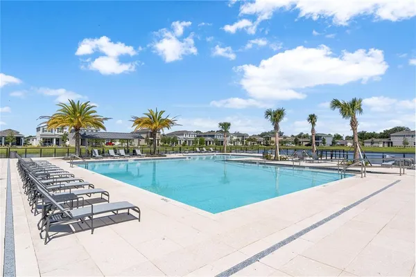 a view of swimming pool with outdoor seating and city view