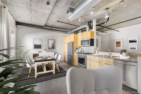 a living room with stainless steel appliances kitchen island granite countertop furniture and a kitchen view