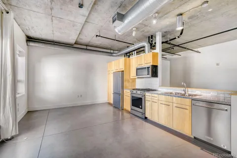 a kitchen with stainless steel appliances a sink and a stove