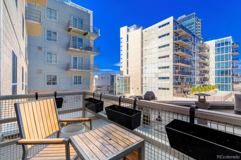 a view of a balcony with two chairs and a table