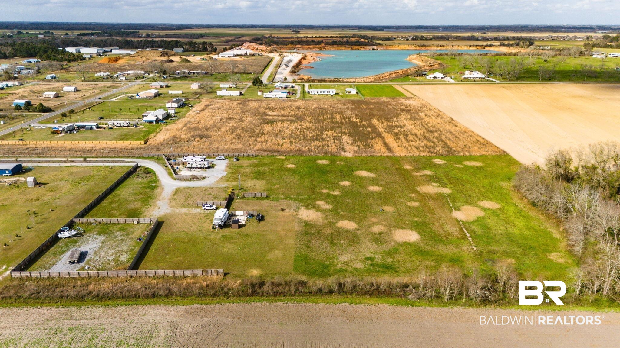 7826 County Road 19 Foley, AL 36535 - Photo 4 of 11 Overview of rural landscape featuring extensive farmland and a nearby body of water