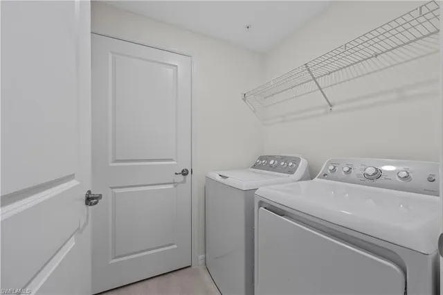 a view of storage and utility room with washer and dryer