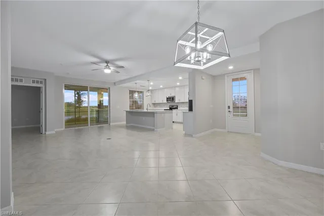 a view of an empty room with a kitchen