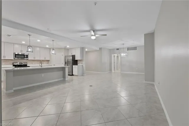 a view of kitchen with refrigerator and window