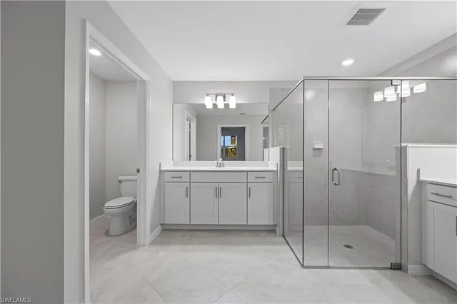 a bathroom with a toilet a sink and shower