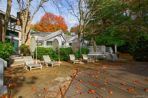 a view of a house with backyard porch and sitting area