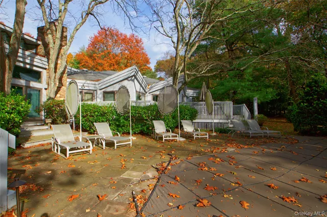 a view of a house with backyard porch and sitting area