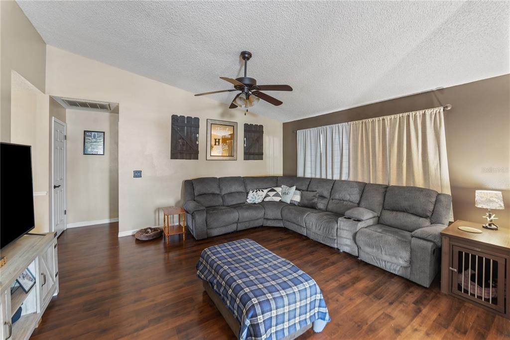 8715 Huntsman Lane Port Richey, FL 34668 - Photo 20 of 54 a living room with furniture and a flat screen tv
