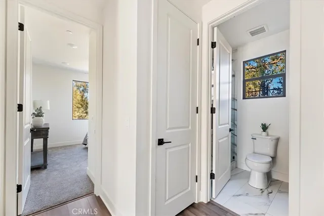 a bathroom with a toilet sink and shower