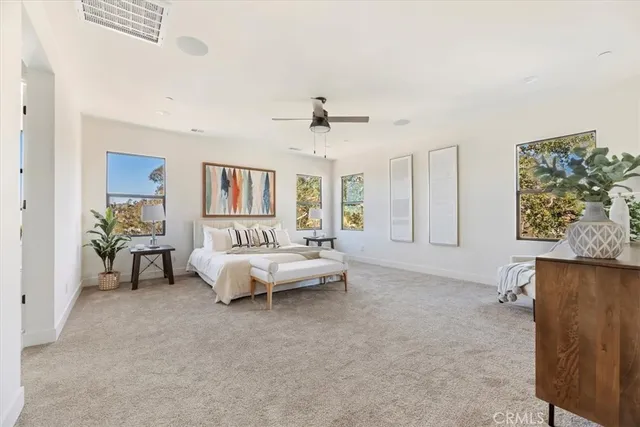 a spacious bedroom with a bed and a chandelier