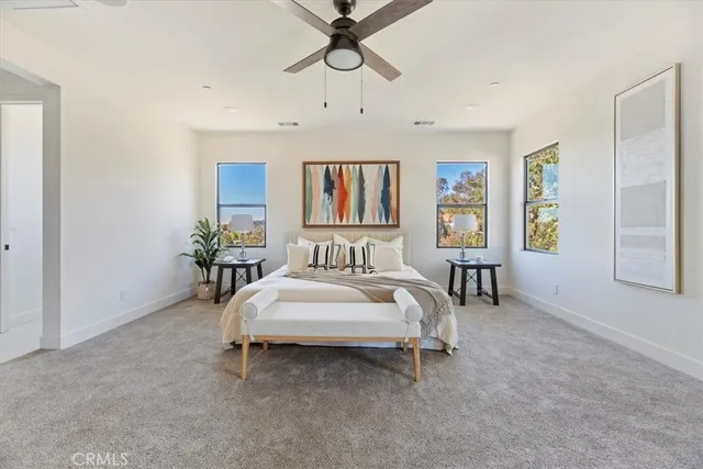 a spacious bedroom with a bed and couch