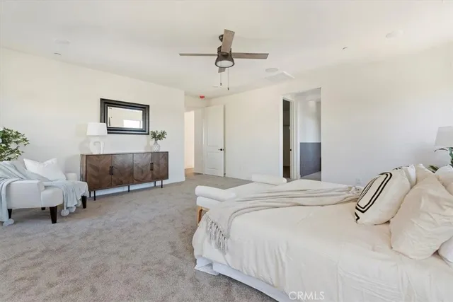 a living room with furniture and a painting on the wall