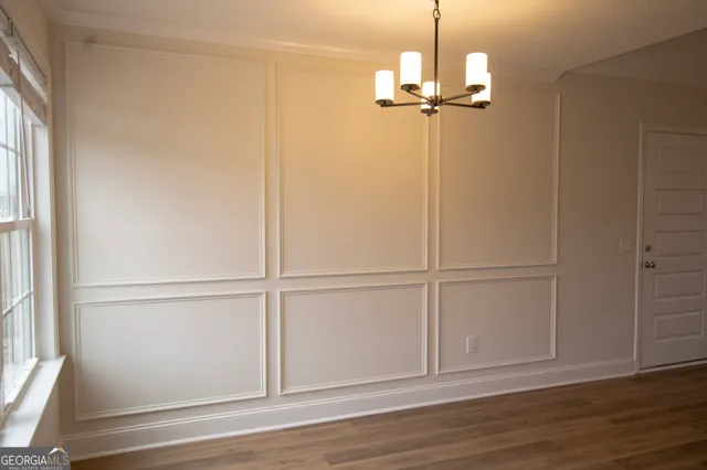 a view of a room with wooden floor closet and windows