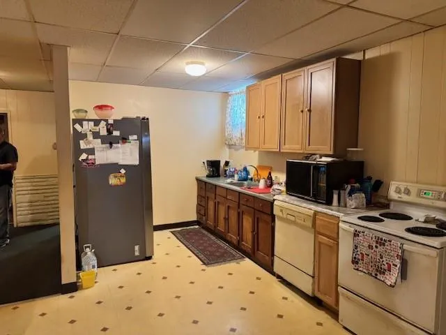 a kitchen with a refrigerator and a stove top oven