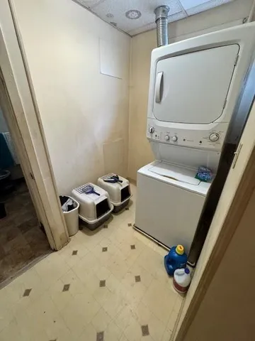 a living room with furniture a flat screen tv and kitchen view