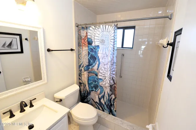 a white toilet sitting next to a bathroom sink