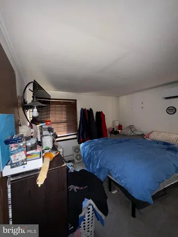 a bed room with furniture and a air conditioner vent