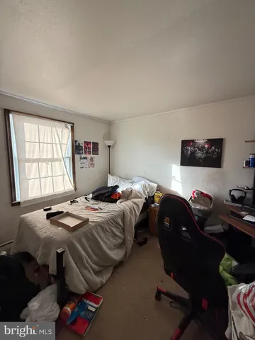 a bedroom with a bed and dresser