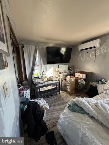 a bedroom with furniture and a flat screen tv