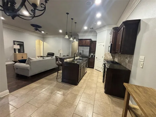 a living room with furniture a flat screen tv and a large mirror