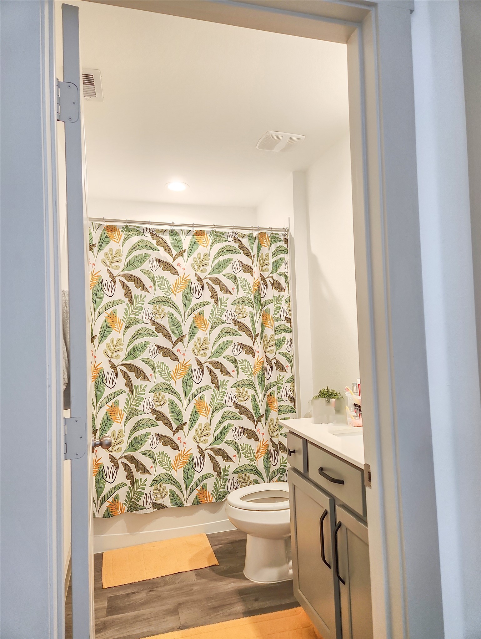7219 Sunbreeze Lane Rosenberg, TX 77469 - Photo 13 of 18 a bathroom with a toilet and a shower curtain