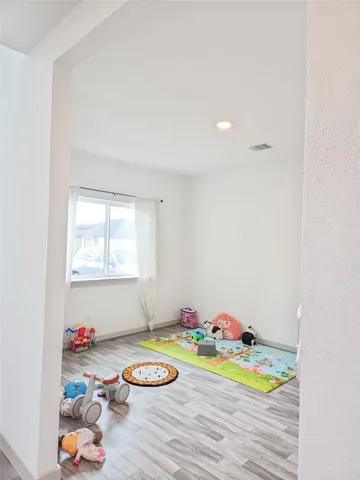 a room with toys and wooden floor