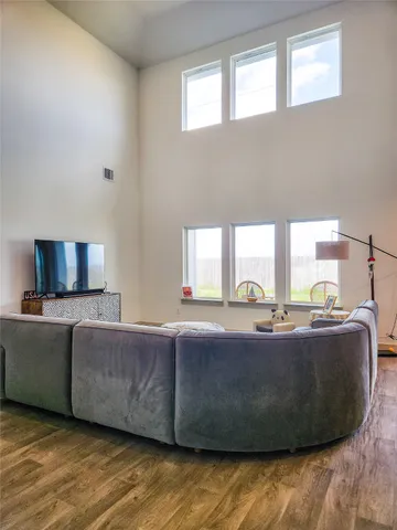 a living room with couches and a flat screen tv