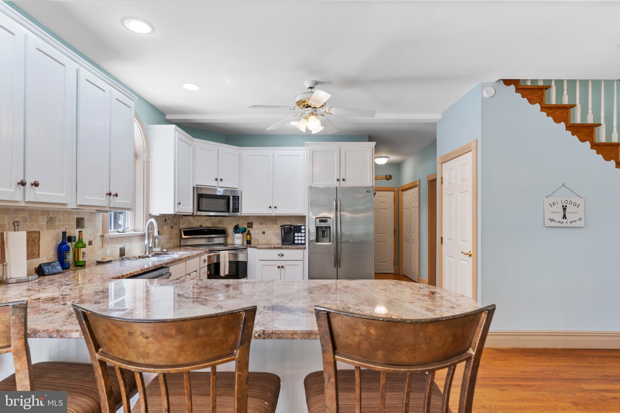 176 Richland Road Carlisle, PA 17015 - Photo 11 of 59 a kitchen with stainless steel appliances granite countertop a stove a refrigerator a sink a stove a dining table and chairs with wooden floor