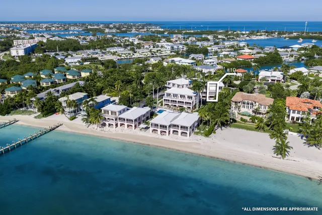 an aerial view of a house with a garden and mountain view in back