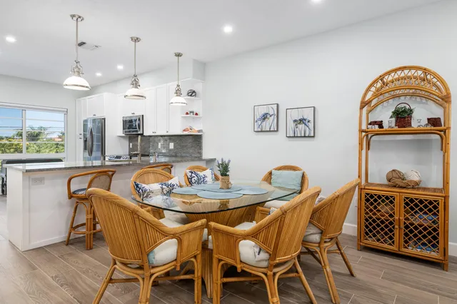 a dining room with furniture and wooden floor