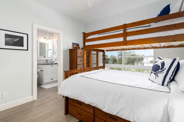 a bed sitting in a spacious bedroom next to a window