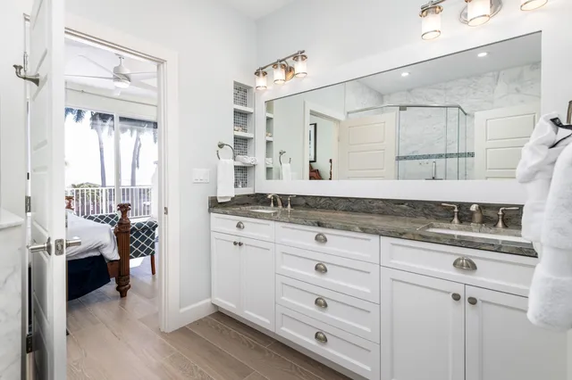 a bathroom with a granite countertop sink a toilet and shower