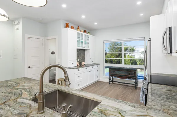 a view of a kitchen with a sink and cabinets