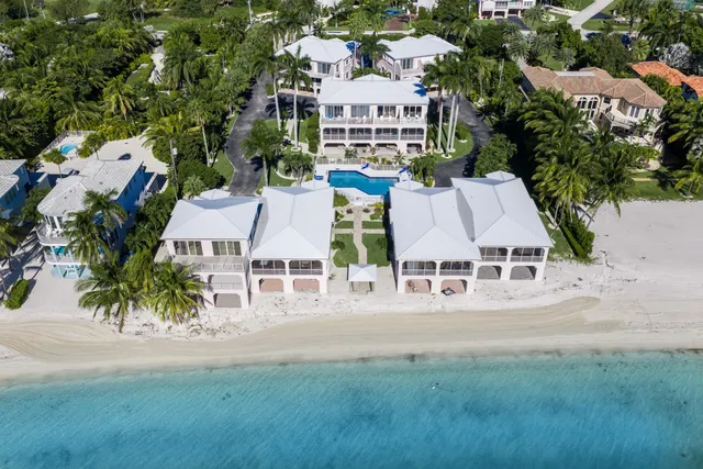 an aerial view of residential houses with yard and car parked