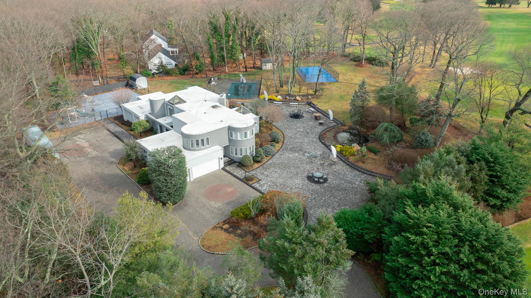 an aerial view of a house with a yard and lake view