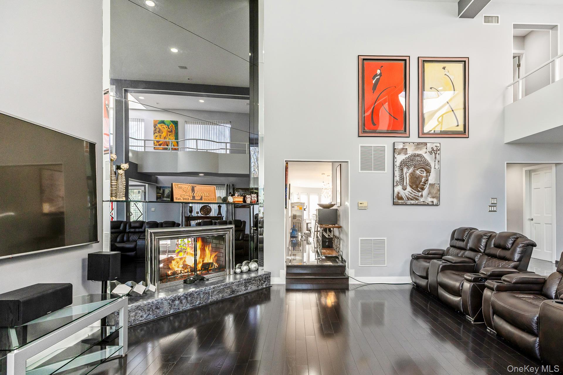 83 Cliff Road Port Jefferson, NY 11777 - Photo 22 of 50 a living room with furniture a flat screen tv and a fireplace