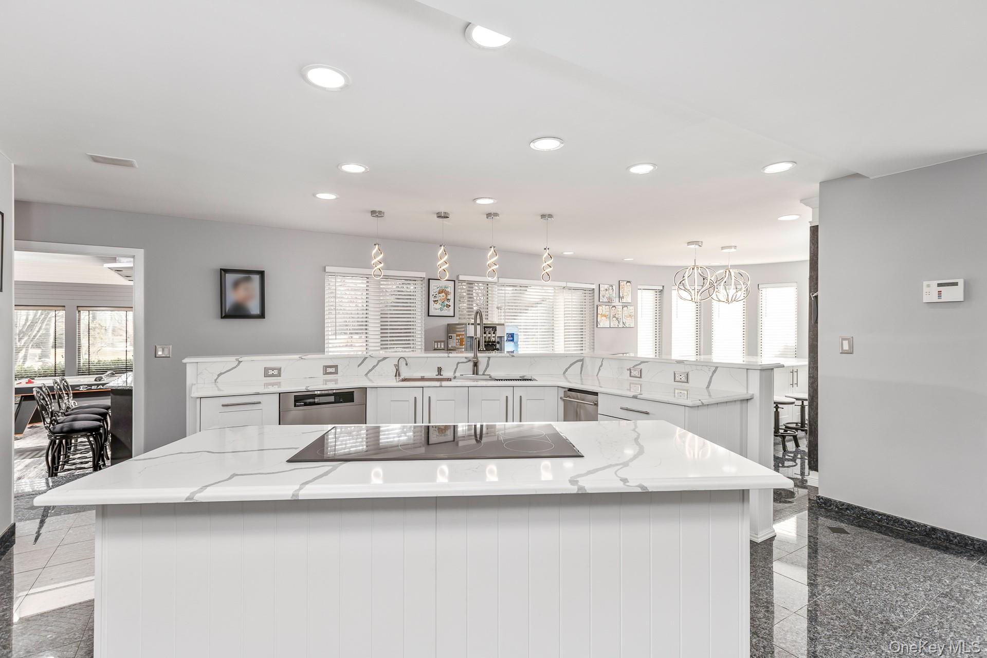 83 Cliff Road Port Jefferson, NY 11777 - Photo 26 of 50 a large kitchen with kitchen island a sink appliances and a counter top space