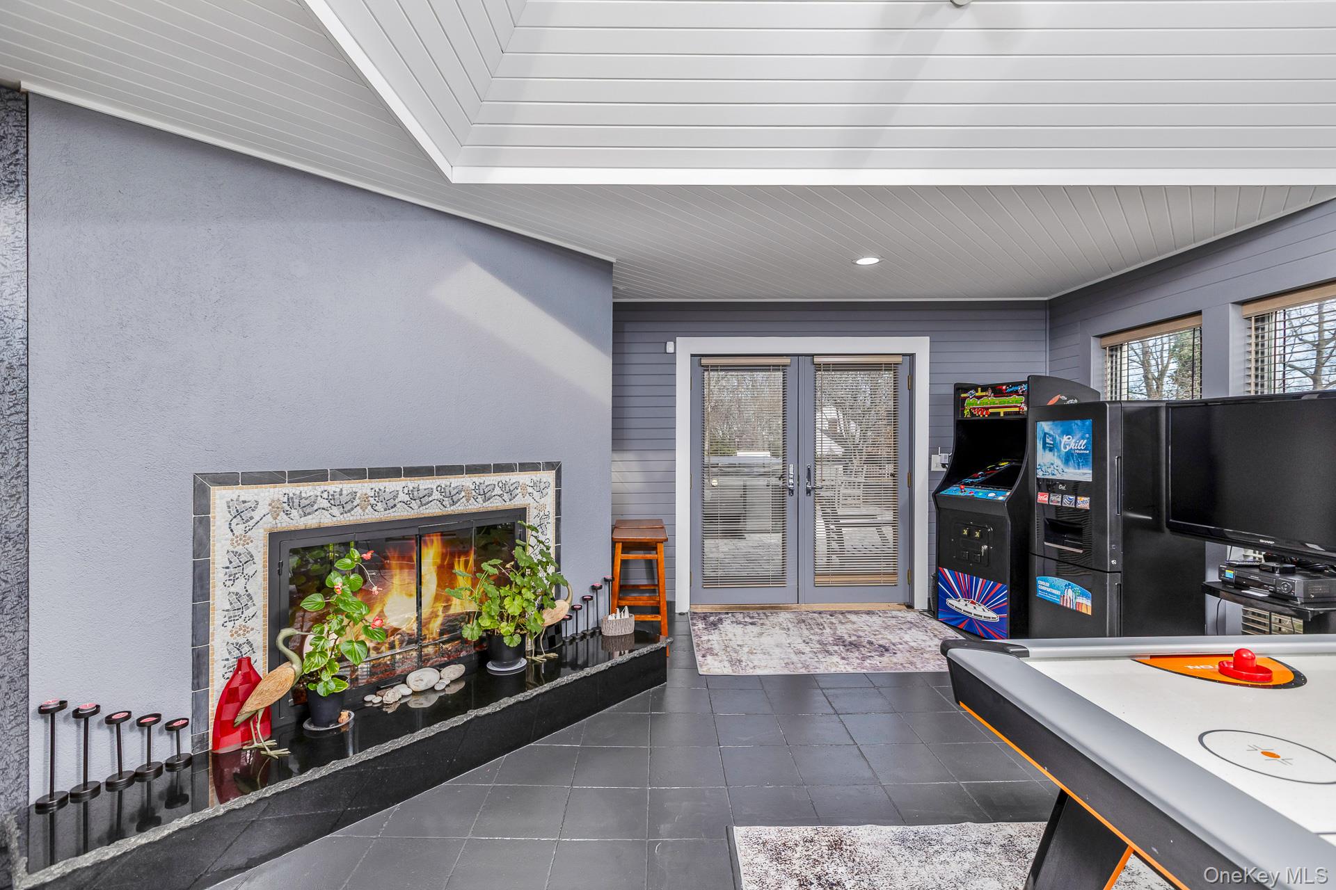 83 Cliff Road Port Jefferson, NY 11777 - Photo 33 of 50 a living room with furniture fireplace and flat screen tv