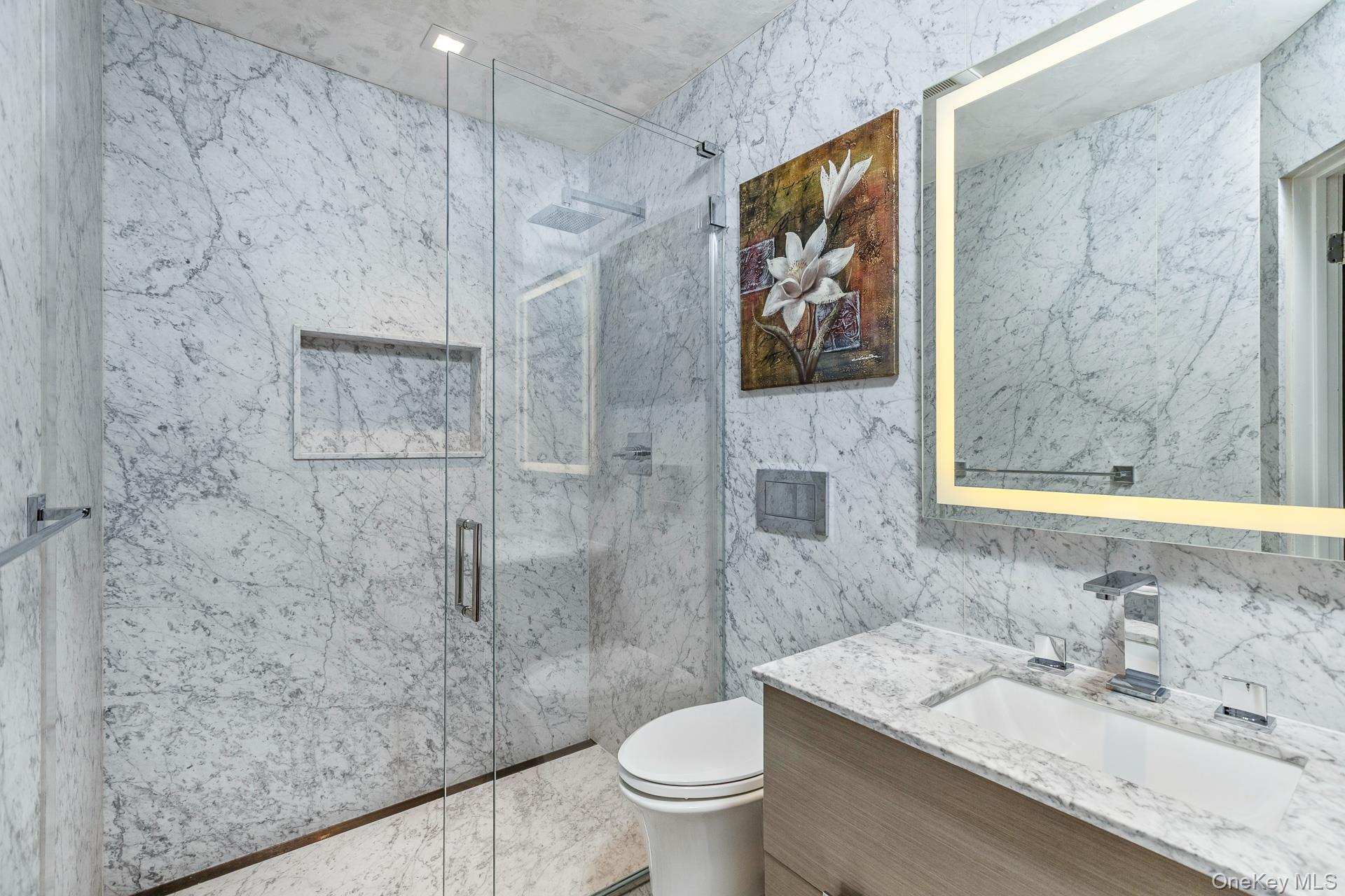 83 Cliff Road Port Jefferson, NY 11777 - Photo 34 of 50 a bathroom with a granite countertop sink a toilet and a shower