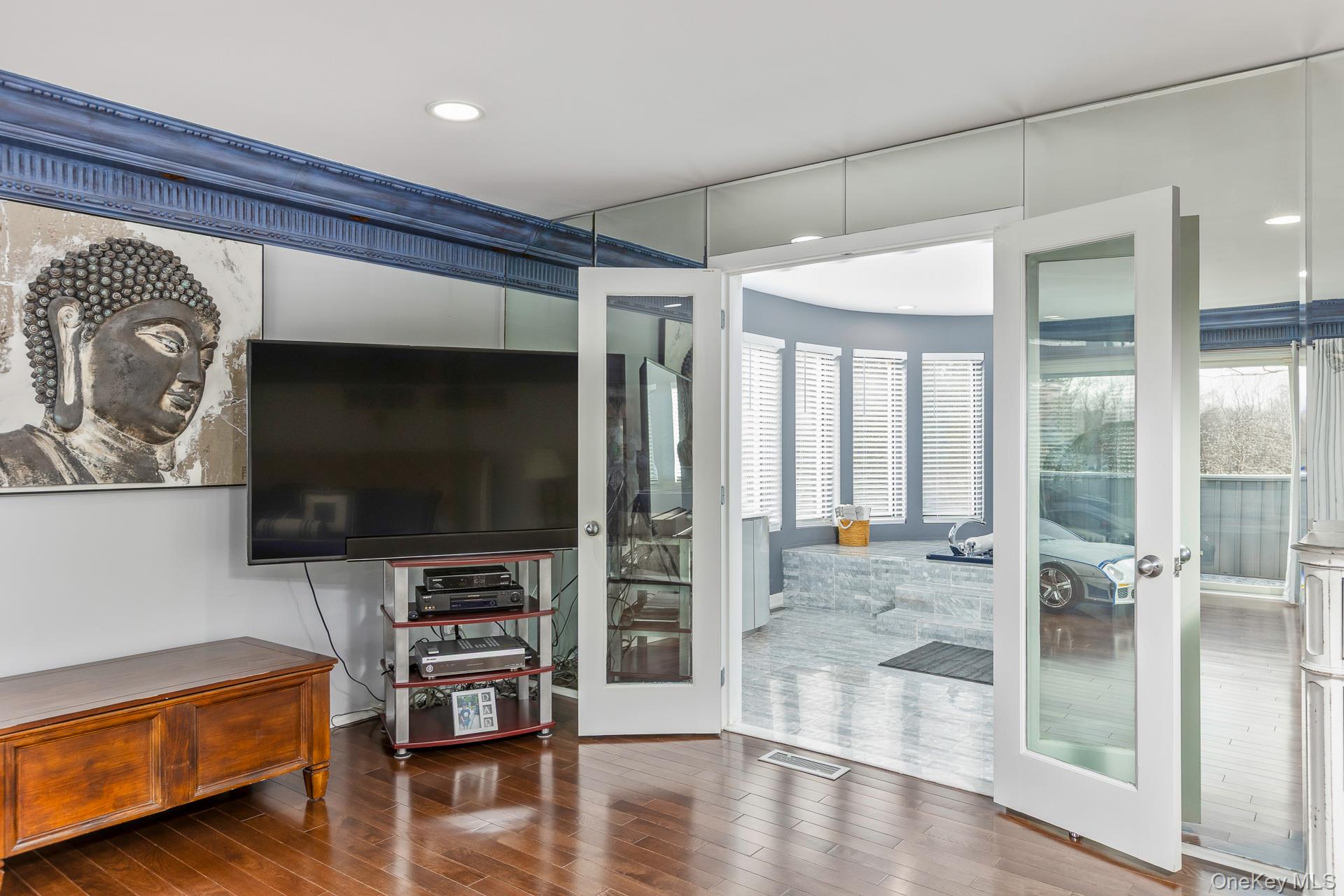 83 Cliff Road Port Jefferson, NY 11777 - Photo 44 of 50 a living room with furniture and a flat screen tv