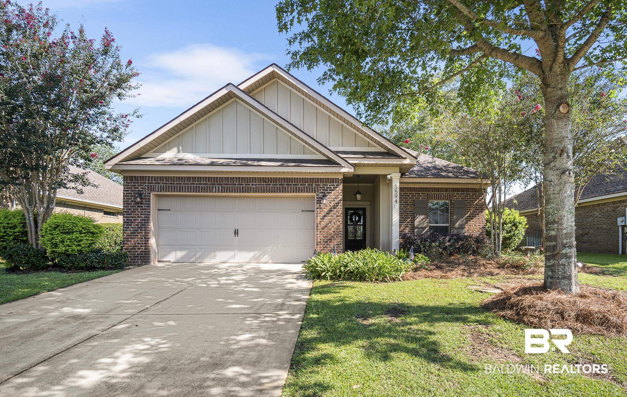 8594 Rosedown Lane Daphne, AL 36526 - Photo 1 of 30 Patio Home featuring brick, board and batten siding, driveway, an attached garage, and a front yard