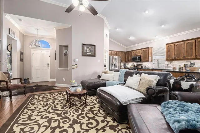 a living room with furniture a fireplace and flat screen tv
