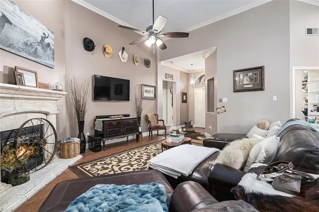 a kitchen with stainless steel appliances a refrigerator a sink a stove a table and chairs