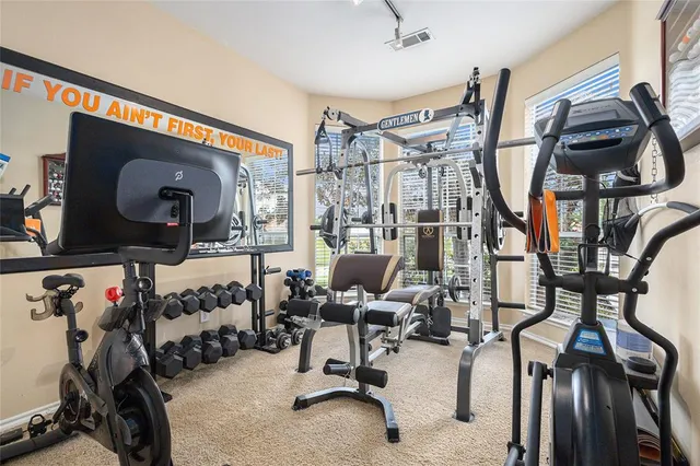a living room with stainless steel appliances kitchen island granite countertop furniture and a large window