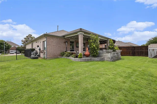 a view of backyard with barbeque grill and wooden fence