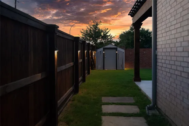 a hallway with wooden floor chandelier and a window