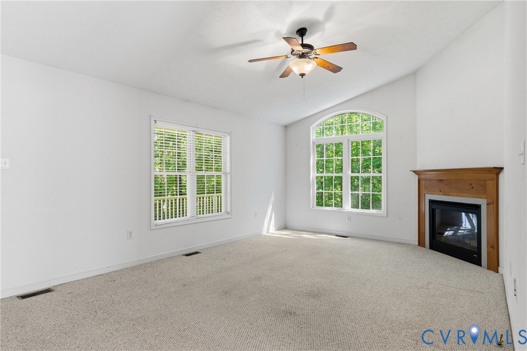 12654 Mt Olive Cohoke Road West Point, VA 23181 - Photo 10 of 31 an empty room with chandelier fan and windows