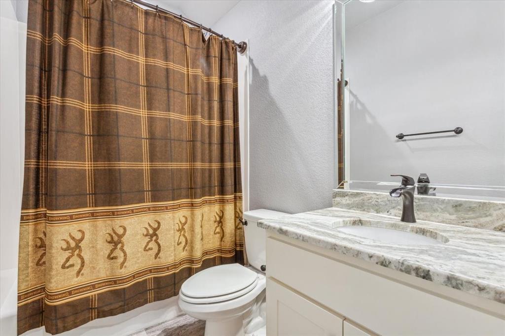 259 County Road 149 Riesel, TX 76682 - Photo 28 of 40 Full bath with toilet, vanity, a shower with shower curtain, and a textured wall