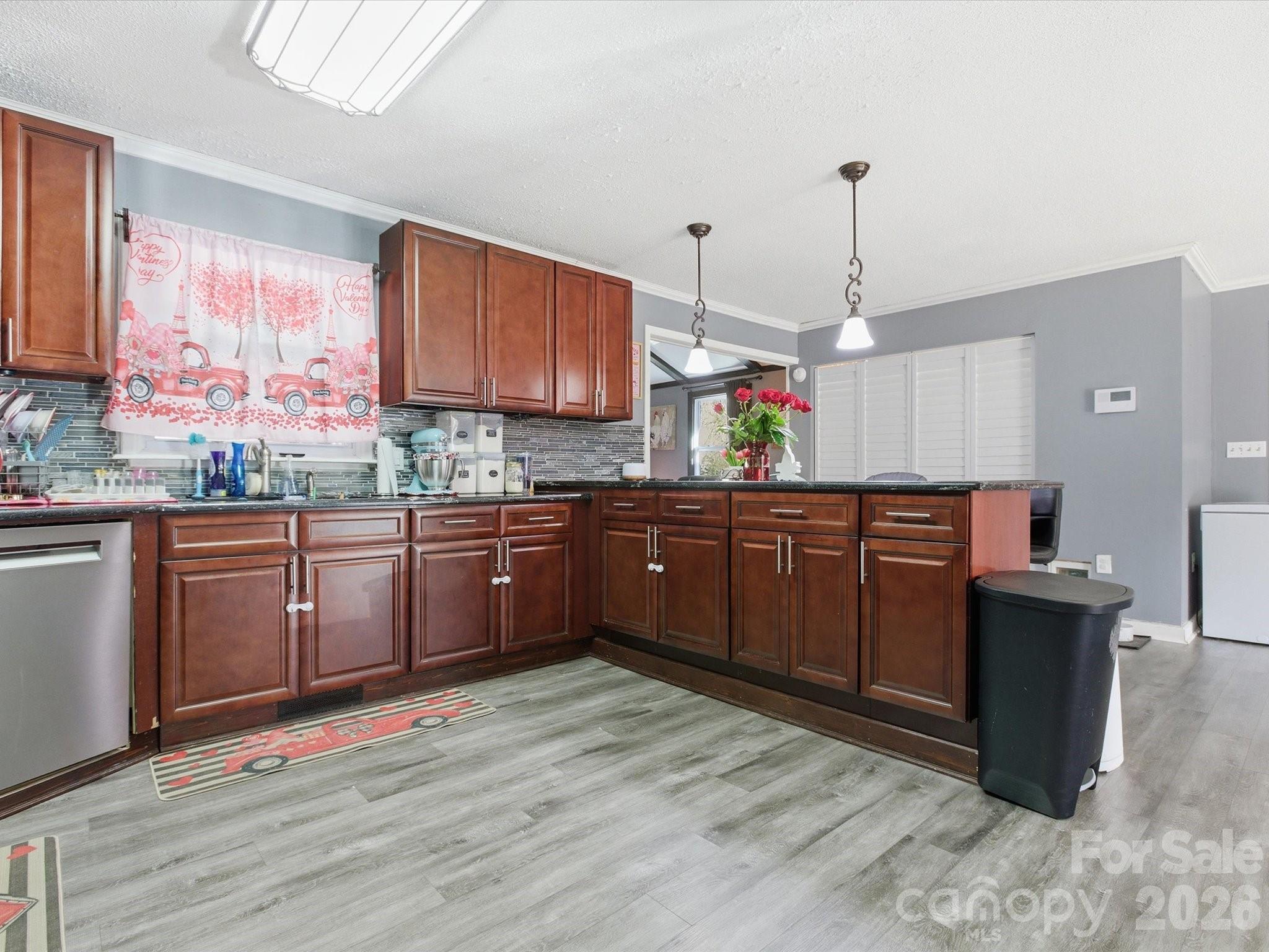 2694 Pineview Drive Lancaster, SC 29720 - Photo 12 of 26 a kitchen with stainless steel appliances kitchen island granite countertop a sink cabinets and wooden floor