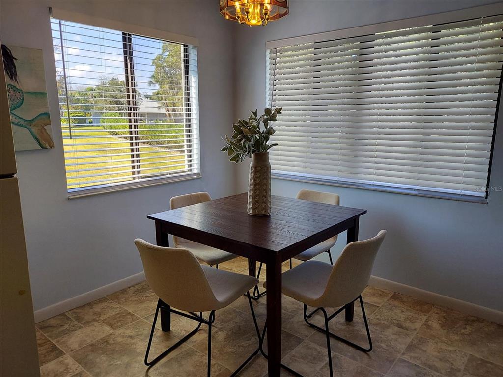 47 Lake Forest Place, Unit 47 Palm Coast, FL 32137 - Photo 11 of 12 a view of a dining room with furniture and window